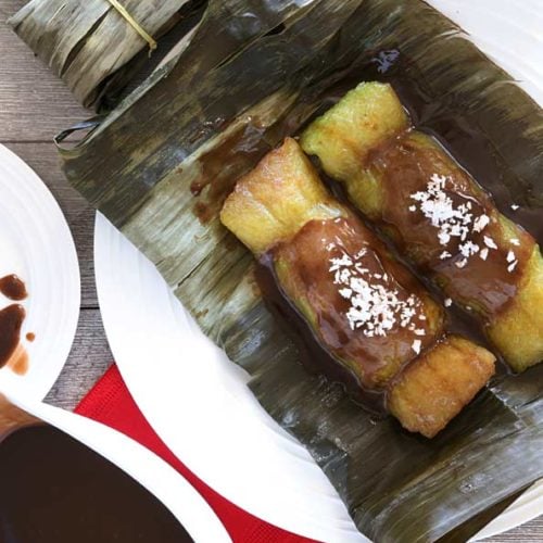 Suman sa Lihiya, a Filipino sticky rice dessert with coconut caramel sauce and grated coconut.